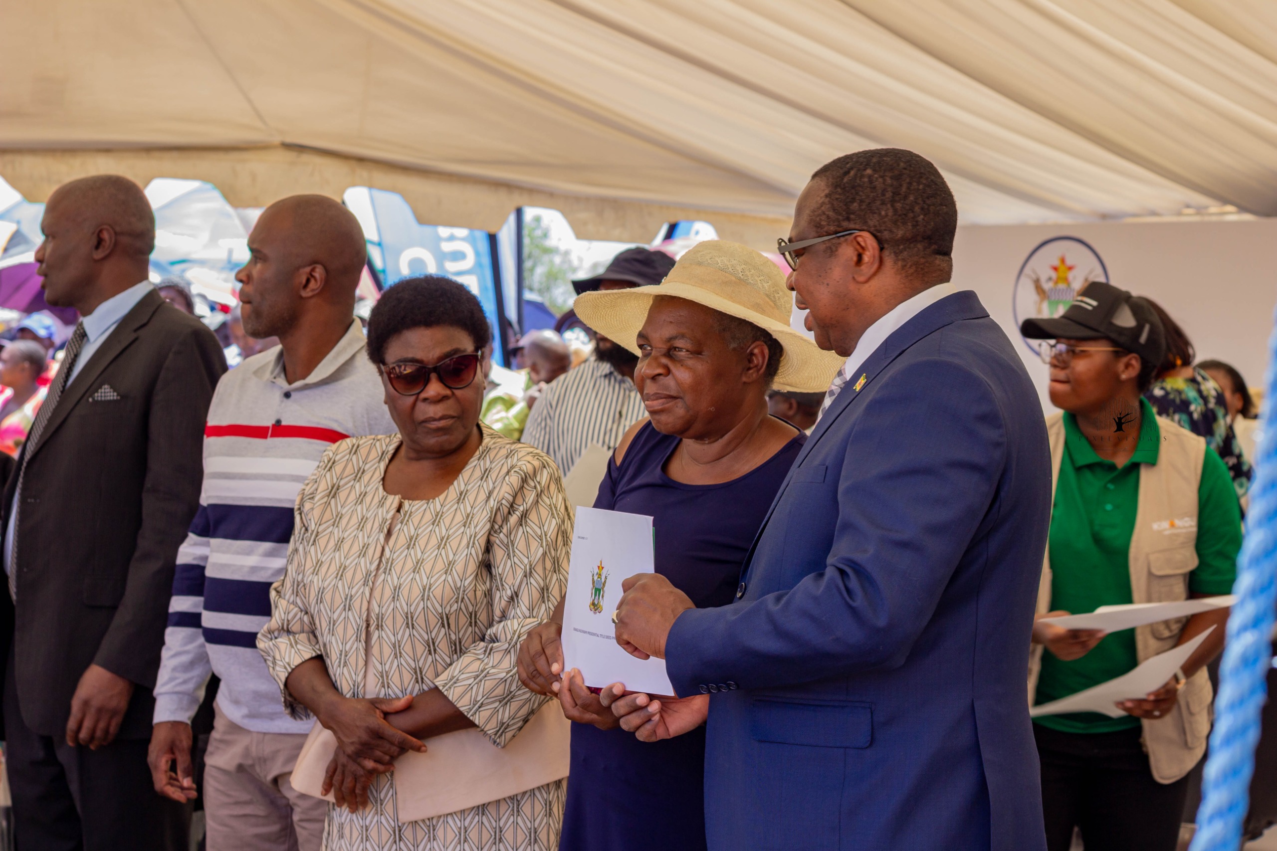Title deed handover led by the Minister during the Epworth ceremony.